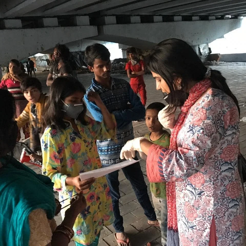 Masked community outreach workers supporting young people during the COVID-19 response in Delhi