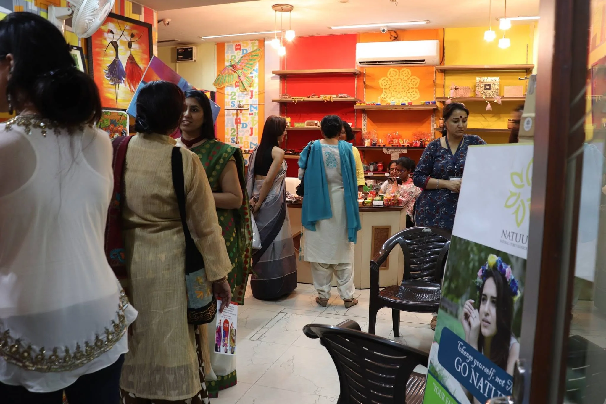 Visitors at a colourful exhibition inside Aumtara