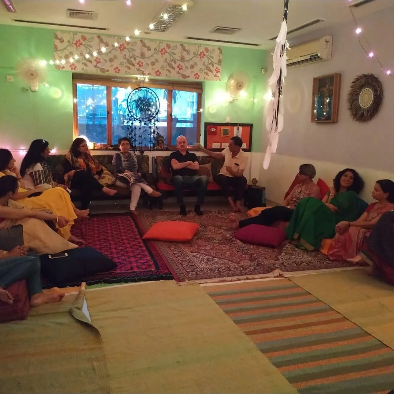 People seated together in a meditation circle at Aumtara
