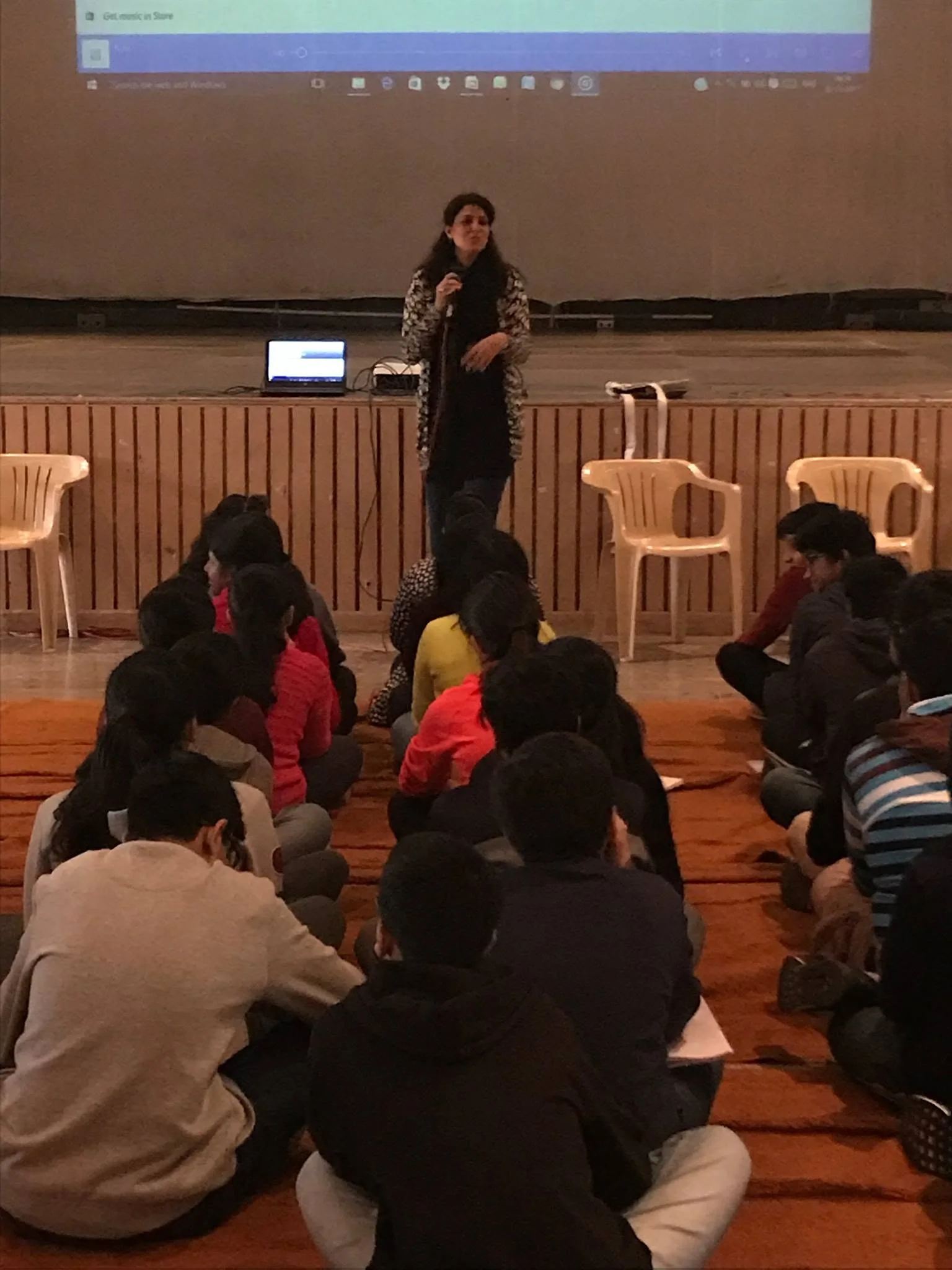 Vibha Gurtu speaking to young adults seated in a hall